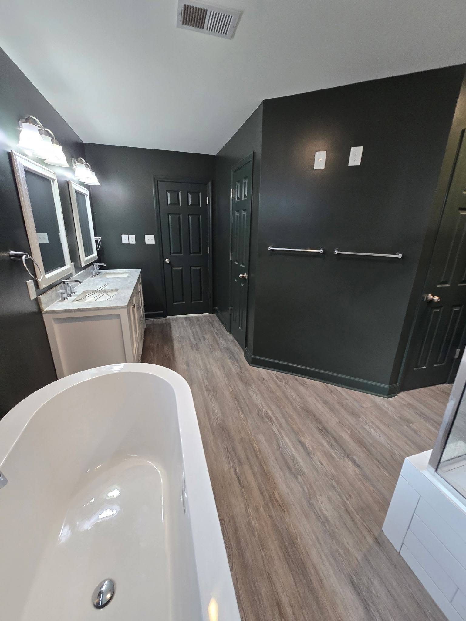 Bathroom renovation featuring freestanding tub and vanity