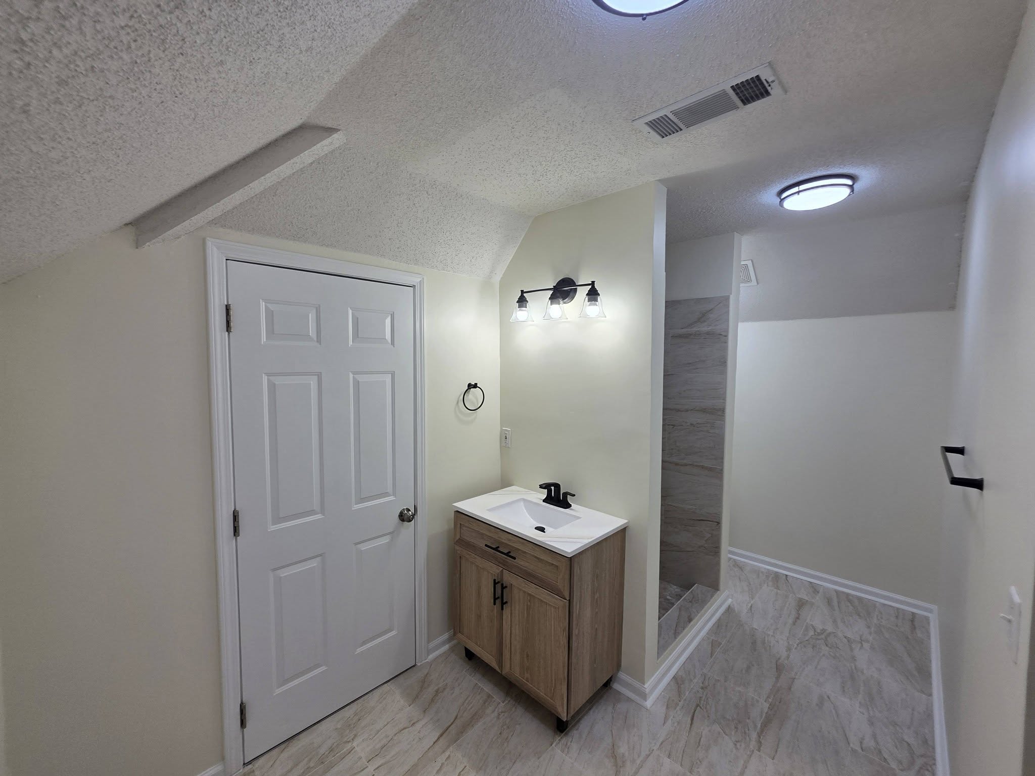 Bathroom renovation with updated flooring and finishes