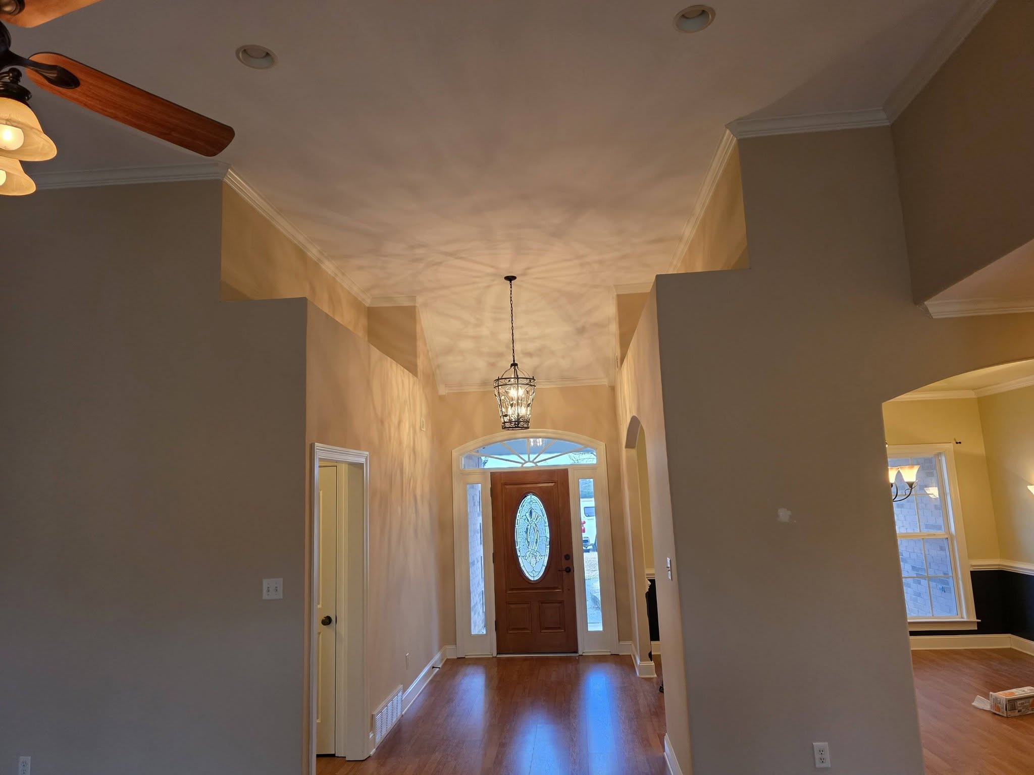 Foyer renovation with drywall, paint, and hardwood floors